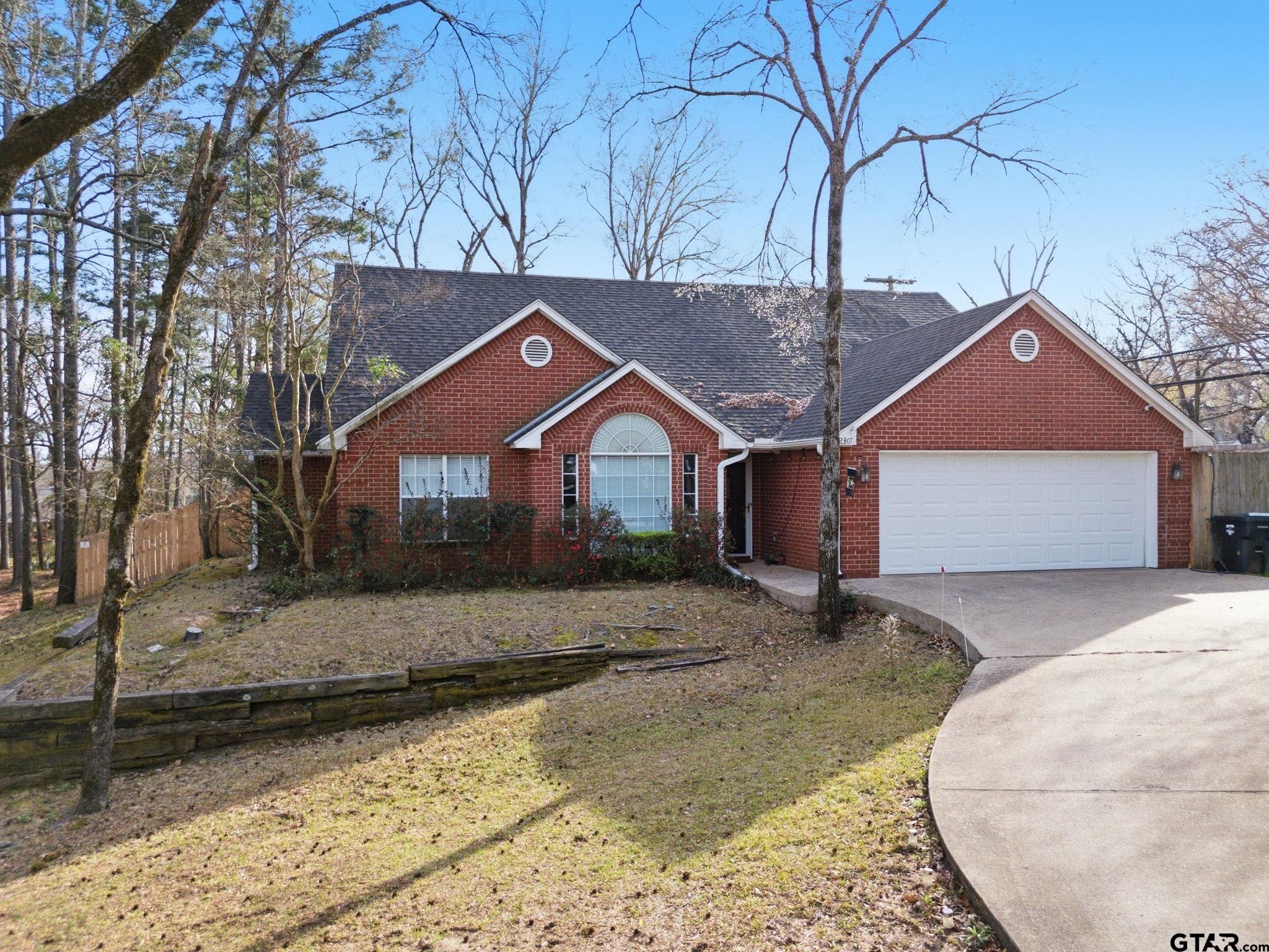 2301 McDonald Road Tyler, TX 75701 - Photo 26 of 26 a front view of a house with a yard covered in snow
