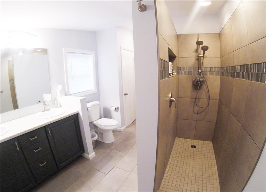1045 Stickle Road Portersville, PA 16051 - Photo 13 of 25 With double-sinks & a modern walk-in shower - this is where convenience meets style!