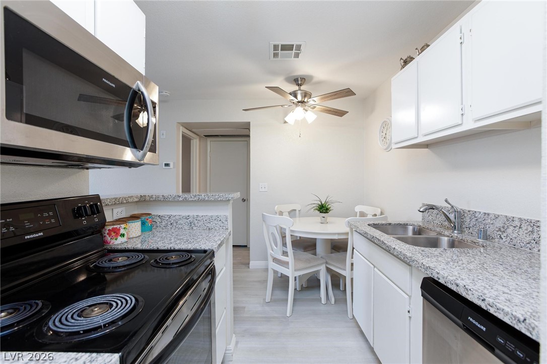 5171 South Lindell Road, Unit 103 Las Vegas, NV 89118 - Photo 13 of 24 Granite counters and stainless steel appliances adorn this efficient culinary space, complete with a casual dining area.