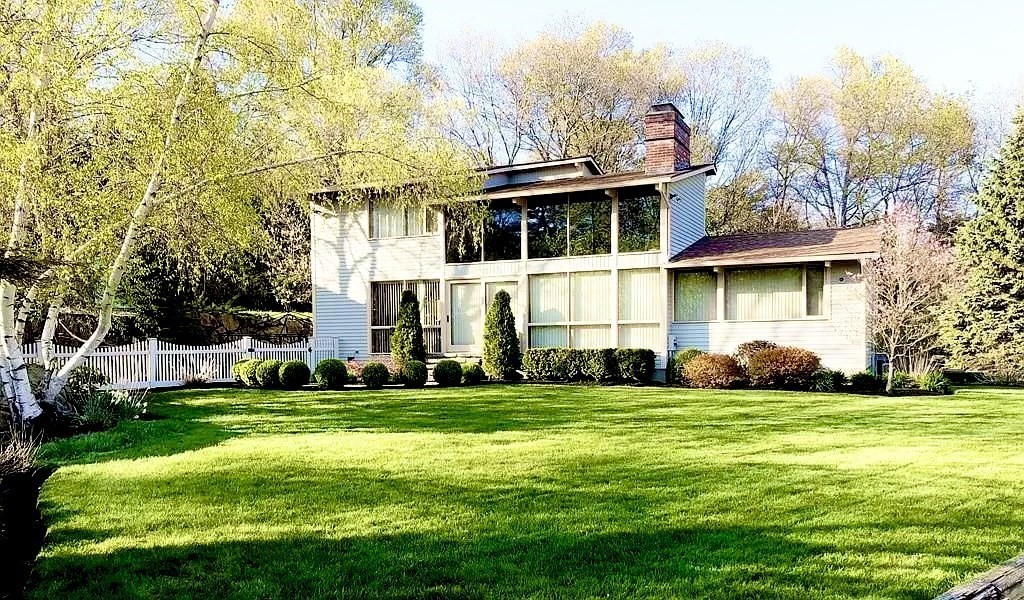 5 Clipper Way Beverly, MA 01915 - Photo 1 of 42 a view of a white house with a big yard and large trees