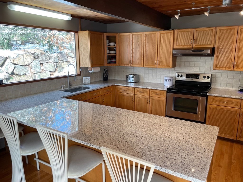5 Clipper Way Beverly, MA 01915 - Photo 13 of 42 a kitchen with stainless steel appliances granite countertop a stove a sink and a microwave