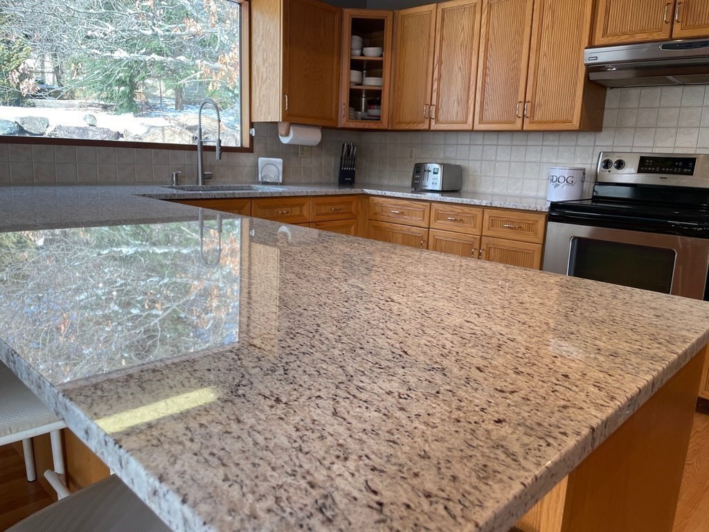 5 Clipper Way Beverly, MA 01915 - Photo 14 of 42 a kitchen with granite countertop a sink and a stove