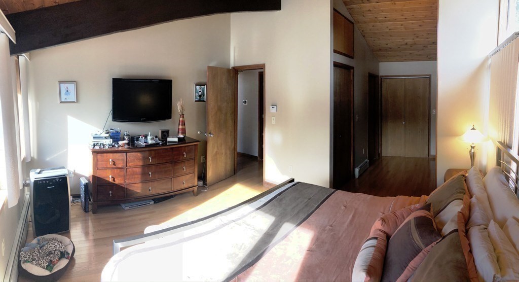 5 Clipper Way Beverly, MA 01915 - Photo 30 of 42 a bedroom with a bed and a flat screen tv