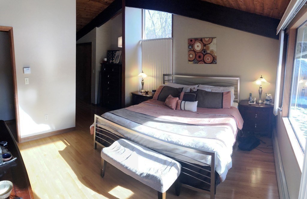 5 Clipper Way Beverly, MA 01915 - Photo 31 of 42 a bedroom with a bed and wooden floor