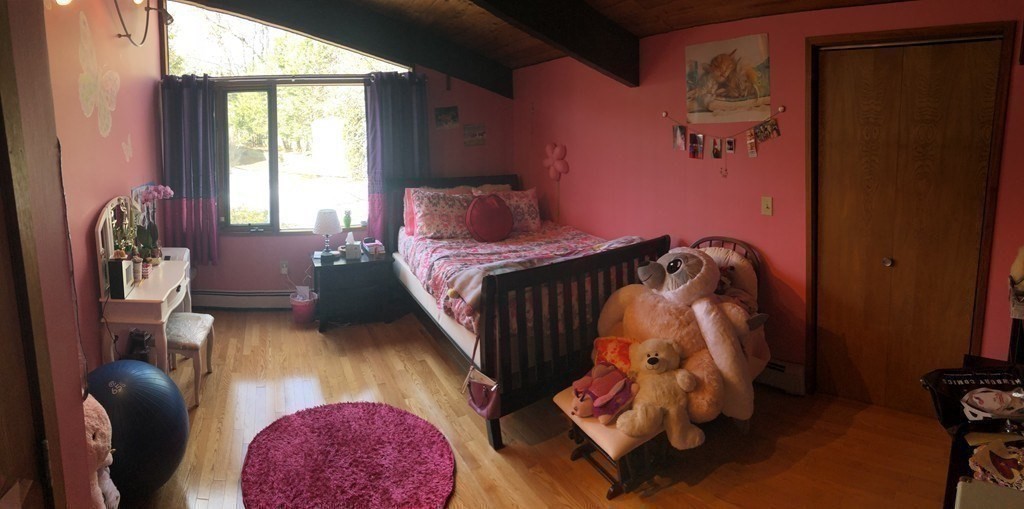 5 Clipper Way Beverly, MA 01915 - Photo 34 of 42 a bedroom with a bed and wooden floor