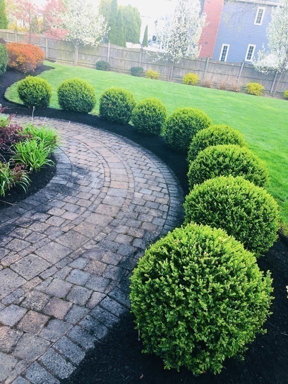 5 Clipper Way Beverly, MA 01915 - Photo 6 of 42 a view of a garden with a building in the background