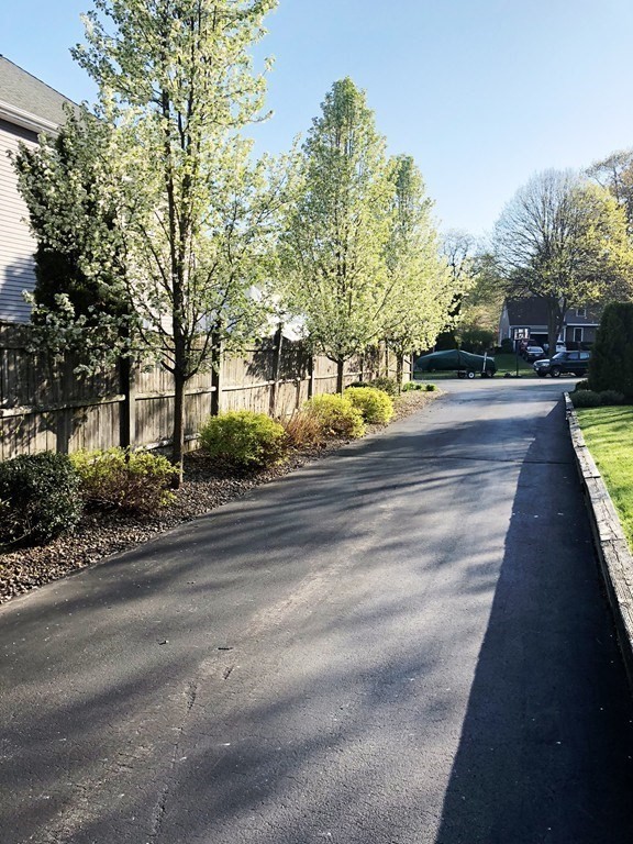 5 Clipper Way Beverly, MA 01915 - Photo 7 of 42 a view of a park with trees and buildings in the background