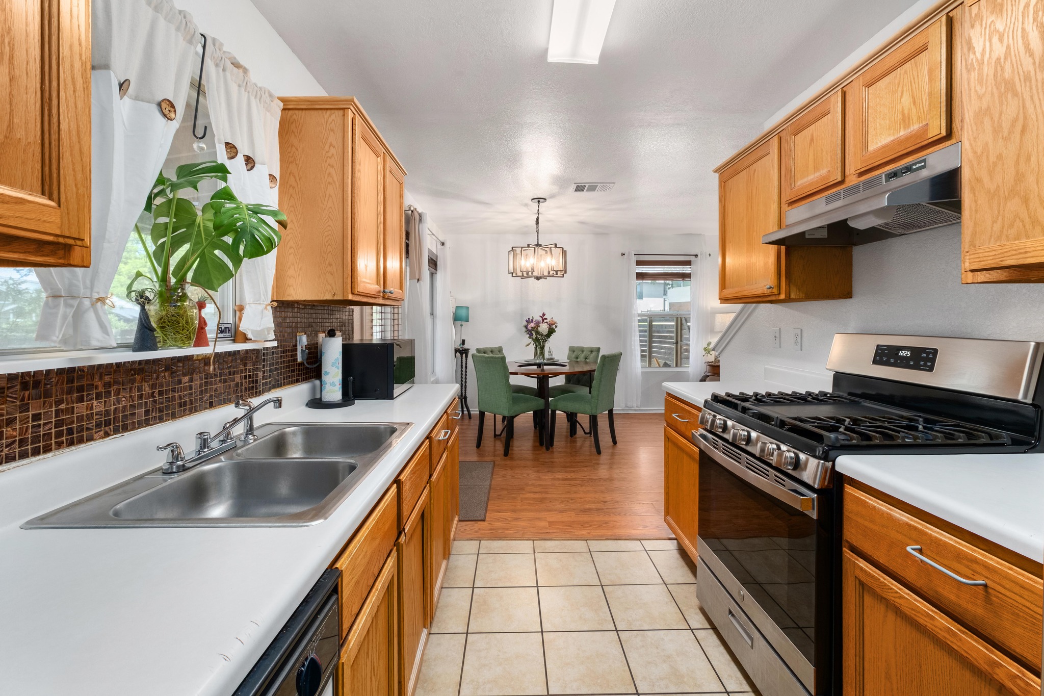 1184 Waller Street Austin, TX 78702 - Photo 6 of 19 a kitchen with stainless steel appliances granite countertop a sink a stove and a refrigerator