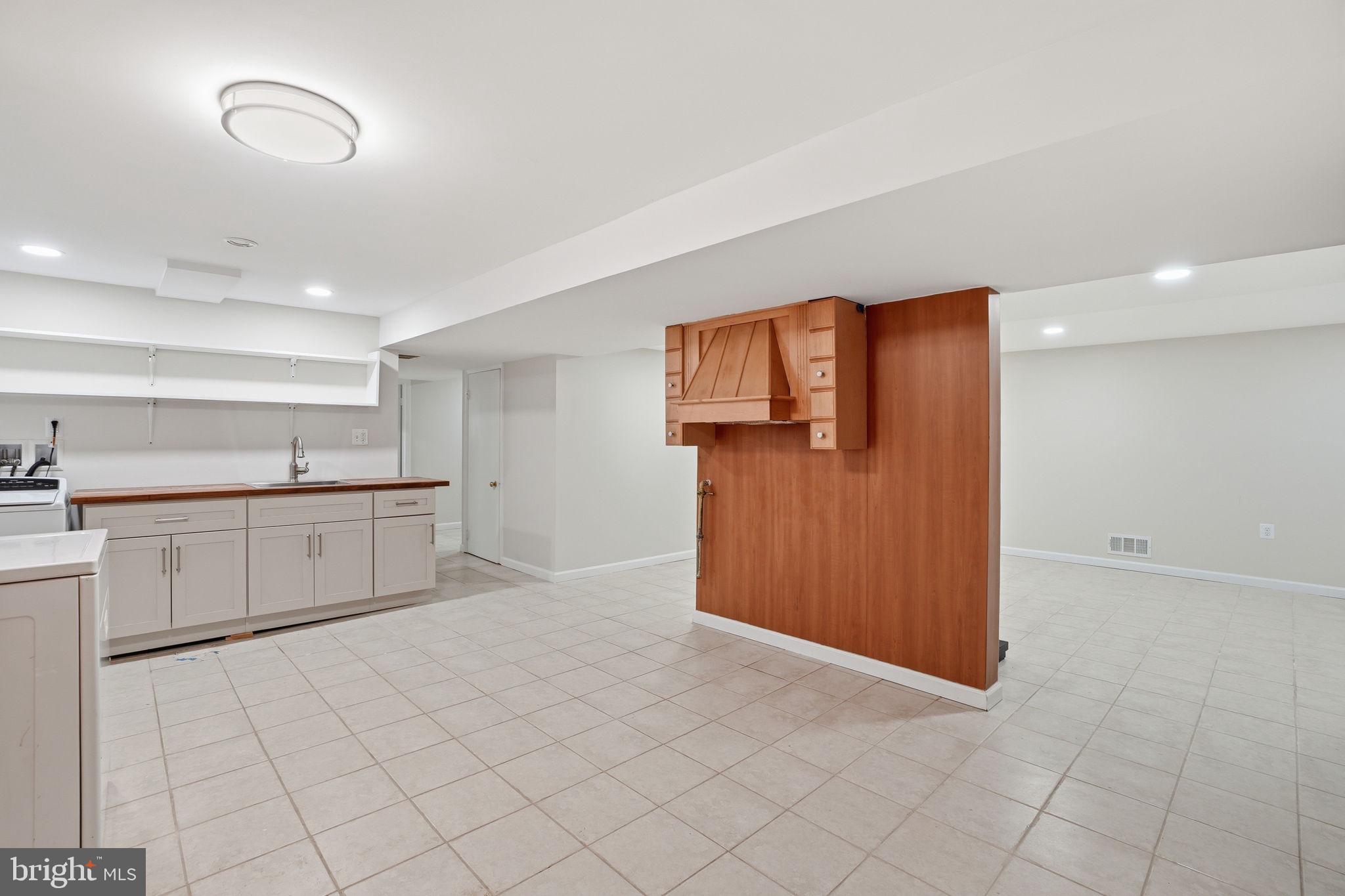 5304 Pillow Lane Springfield, VA 22151 - Photo 25 of 32 a kitchen with white cabinets and refrigerator