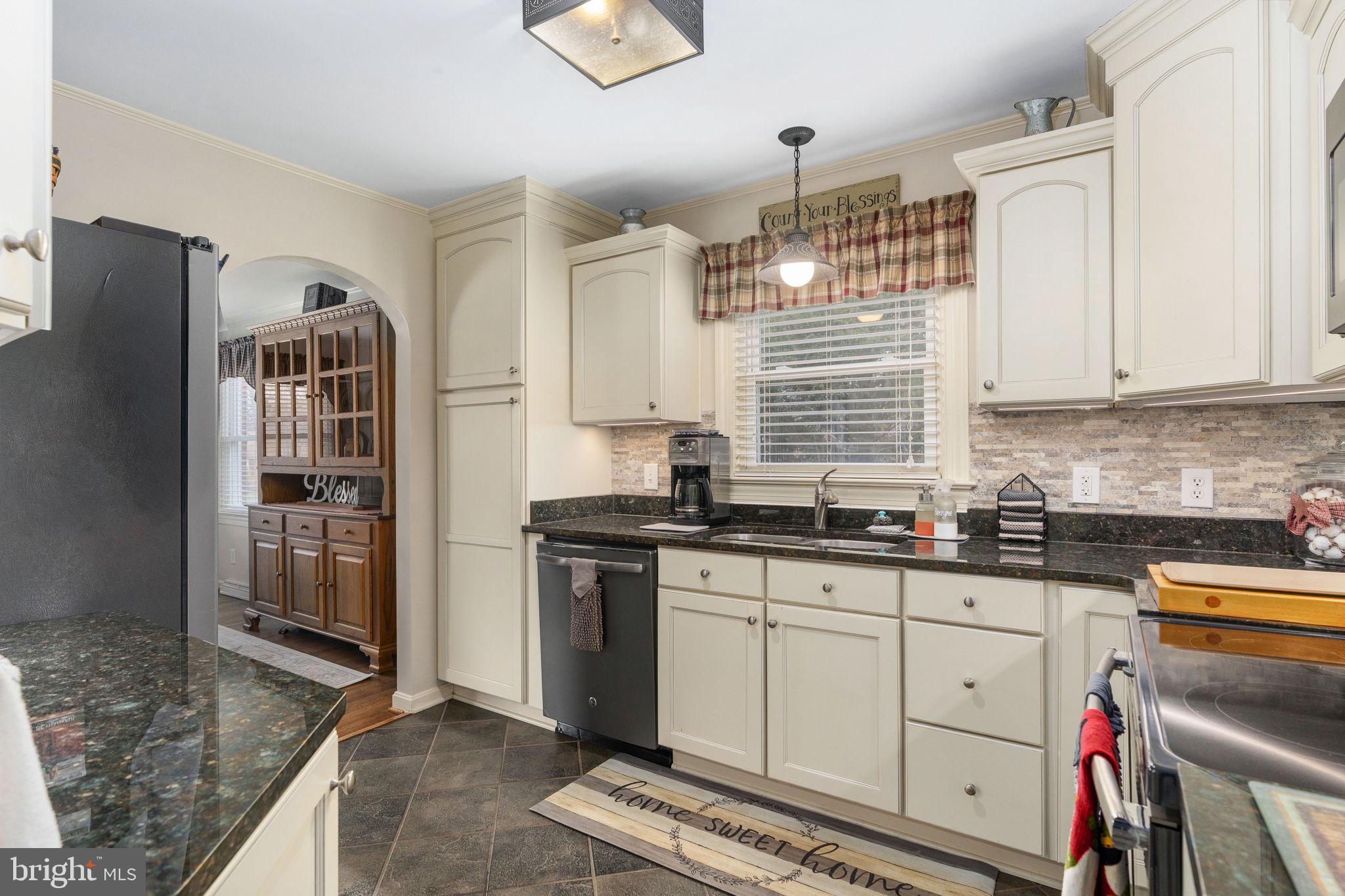 511 Ferry Road Fredericksburg, VA 22405 - Photo 19 of 55 a kitchen with granite countertop a sink a counter space appliances and cabinets