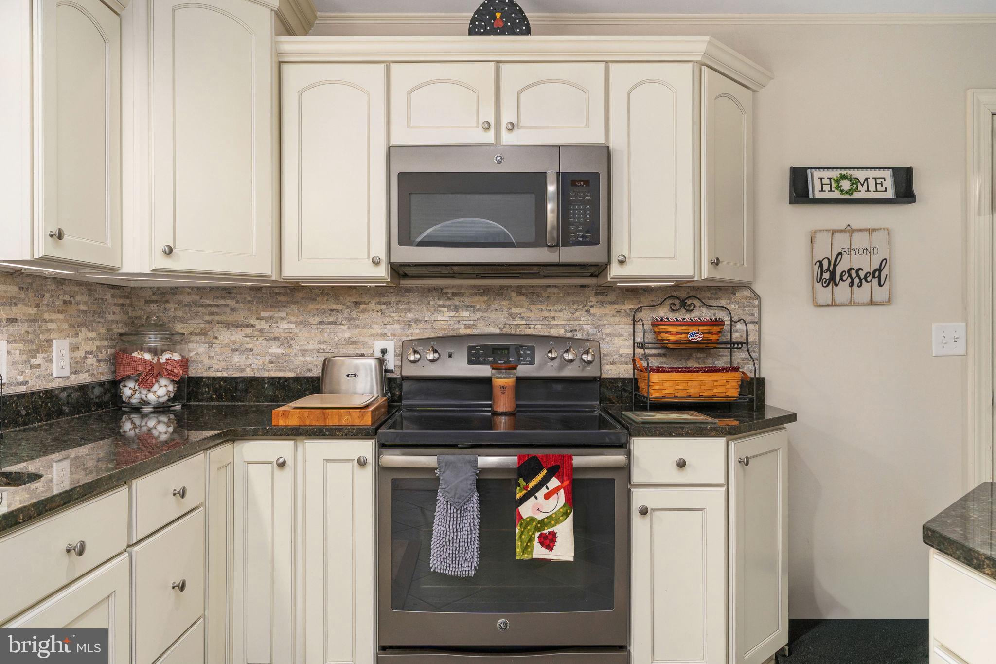 511 Ferry Road Fredericksburg, VA 22405 - Photo 21 of 55 a kitchen with stainless steel appliances granite countertop a stove and a microwave
