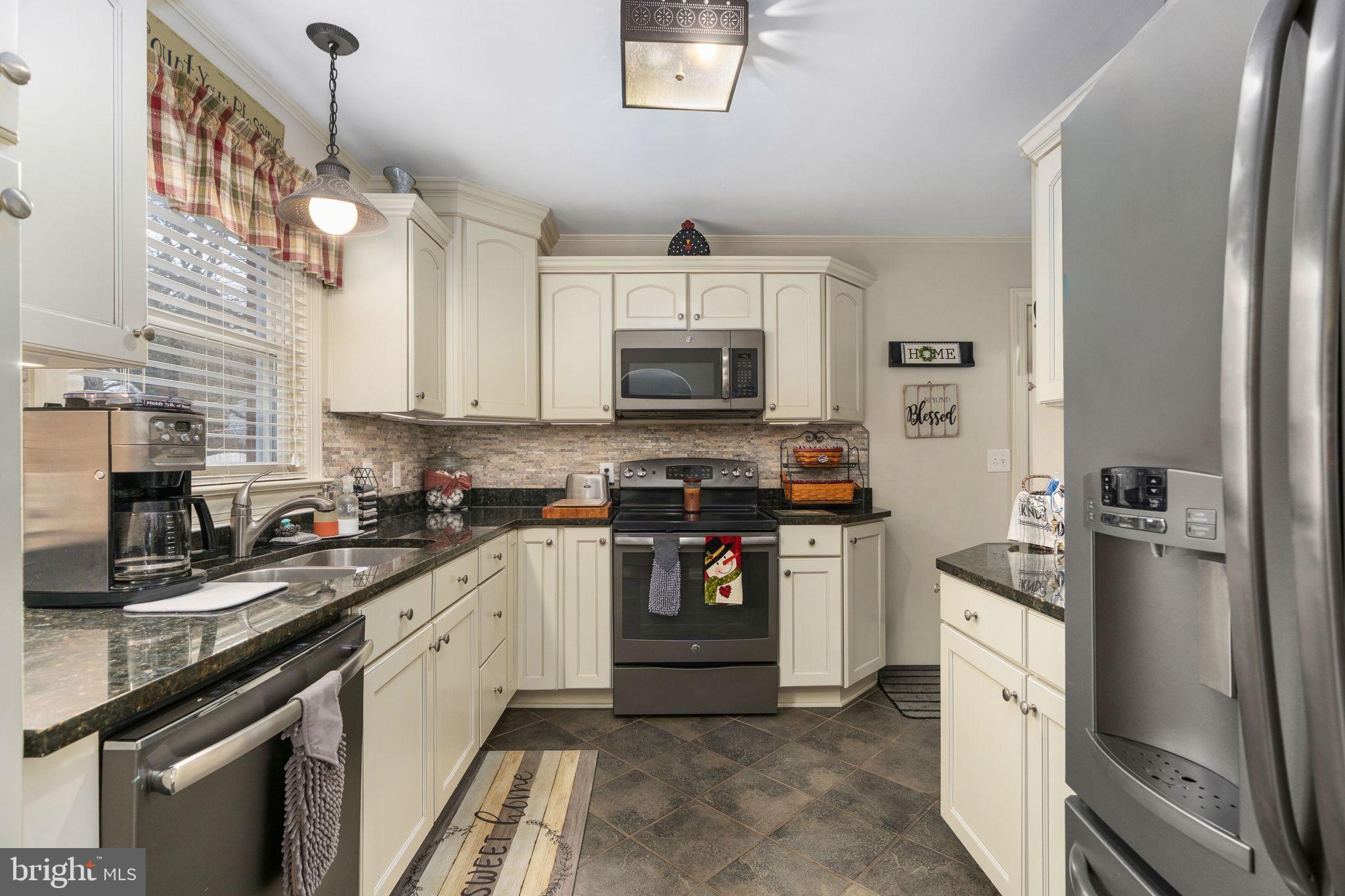 511 Ferry Road Fredericksburg, VA 22405 - Photo 23 of 55 a kitchen with stainless steel appliances granite countertop a refrigerator a stove and a sink