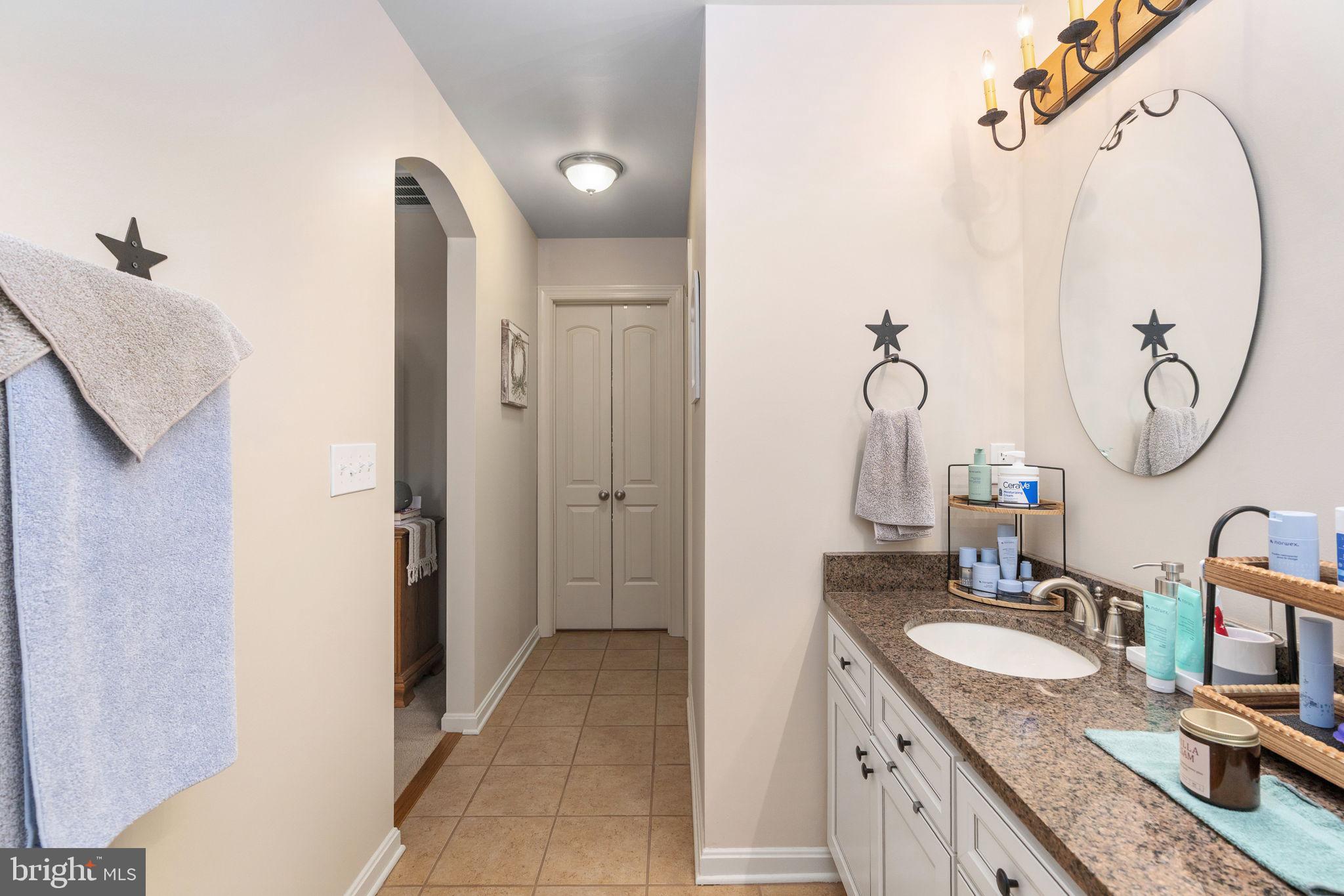 511 Ferry Road Fredericksburg, VA 22405 - Photo 27 of 55 a bathroom with a granite countertop sink and a mirror