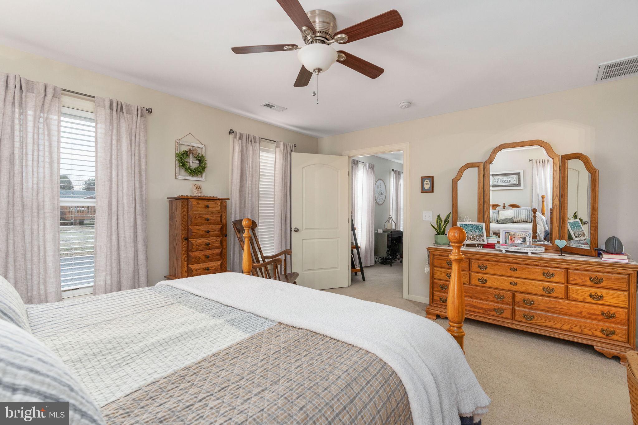 511 Ferry Road Fredericksburg, VA 22405 - Photo 30 of 55 a bedroom with a large bed and a chandelier