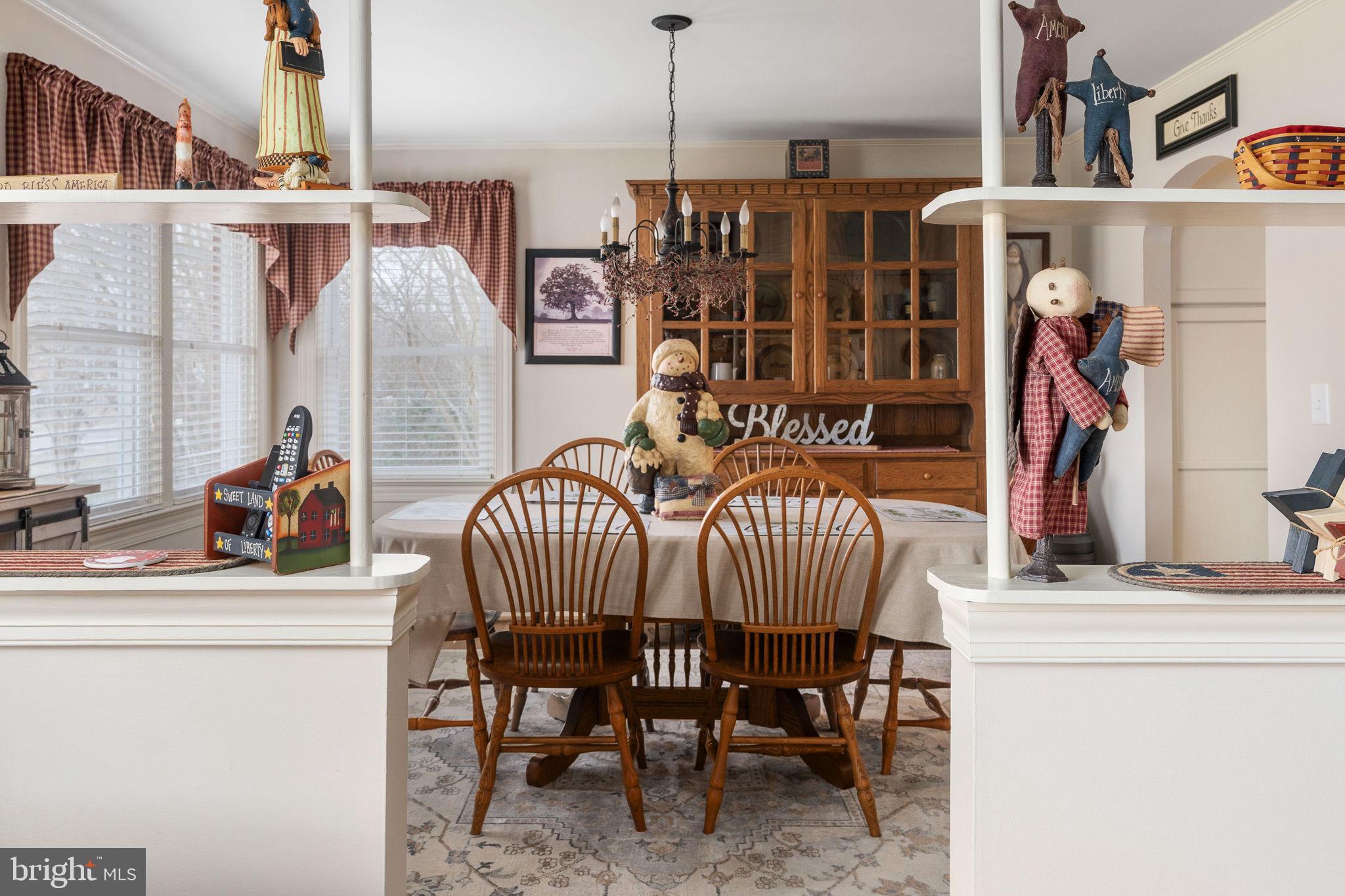 511 Ferry Road Fredericksburg, VA 22405 - Photo 8 of 55 a view of dining room and livingroom with furniture wooden floor windows and a chandelier