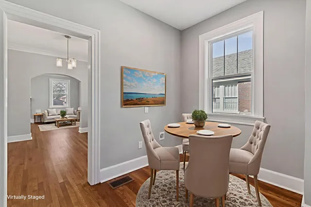 a dining room with furniture and wooden floor