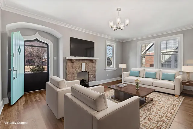 a living room with furniture a fireplace and a flat screen tv