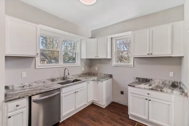 a kitchen with stainless steel appliances granite countertop a sink stove and cabinets