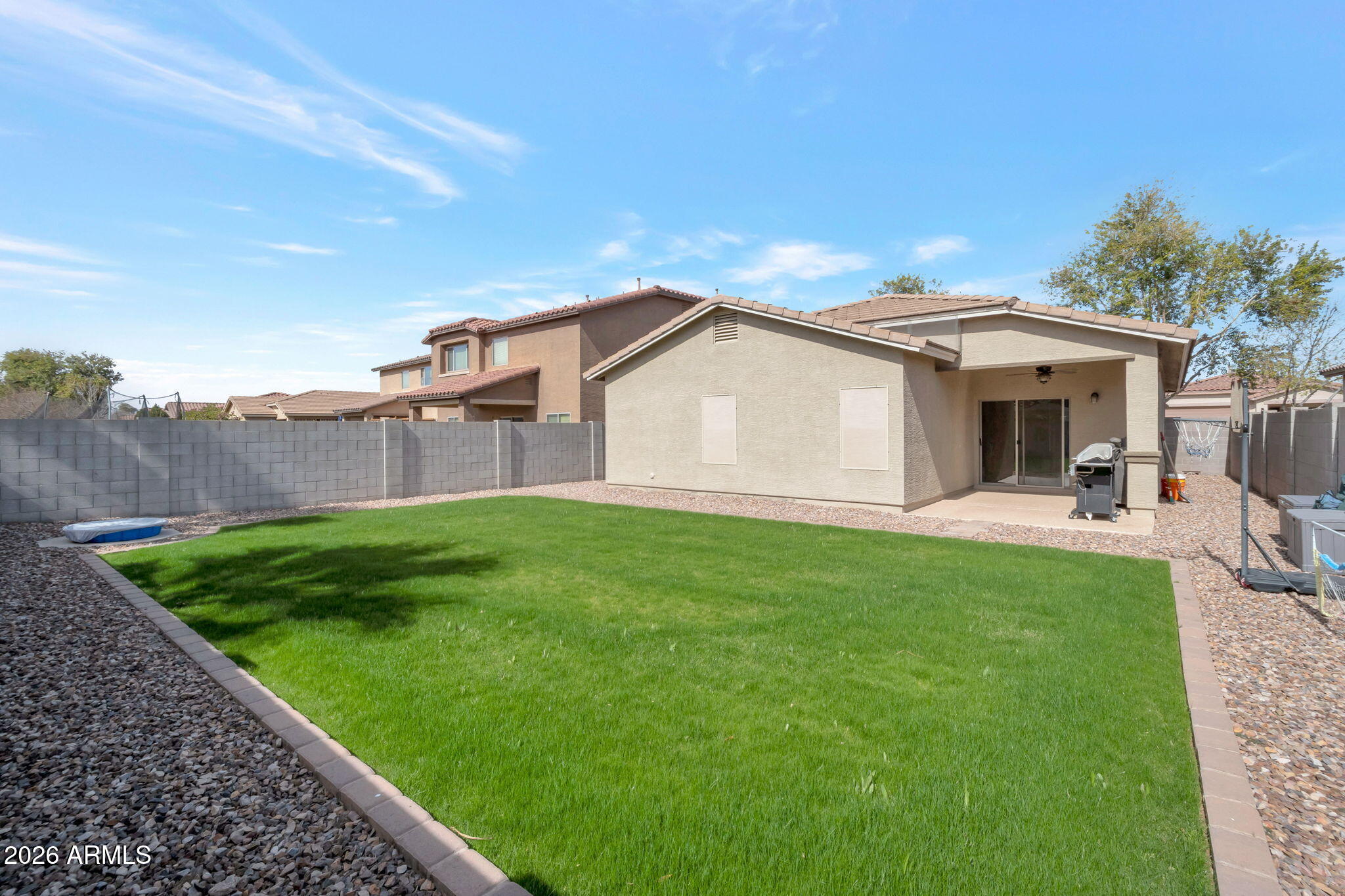225 West Reeves Avenue Queen Creek, AZ 85140 - Photo 14 of 25 a view of a white house with a big yard plants and large trees