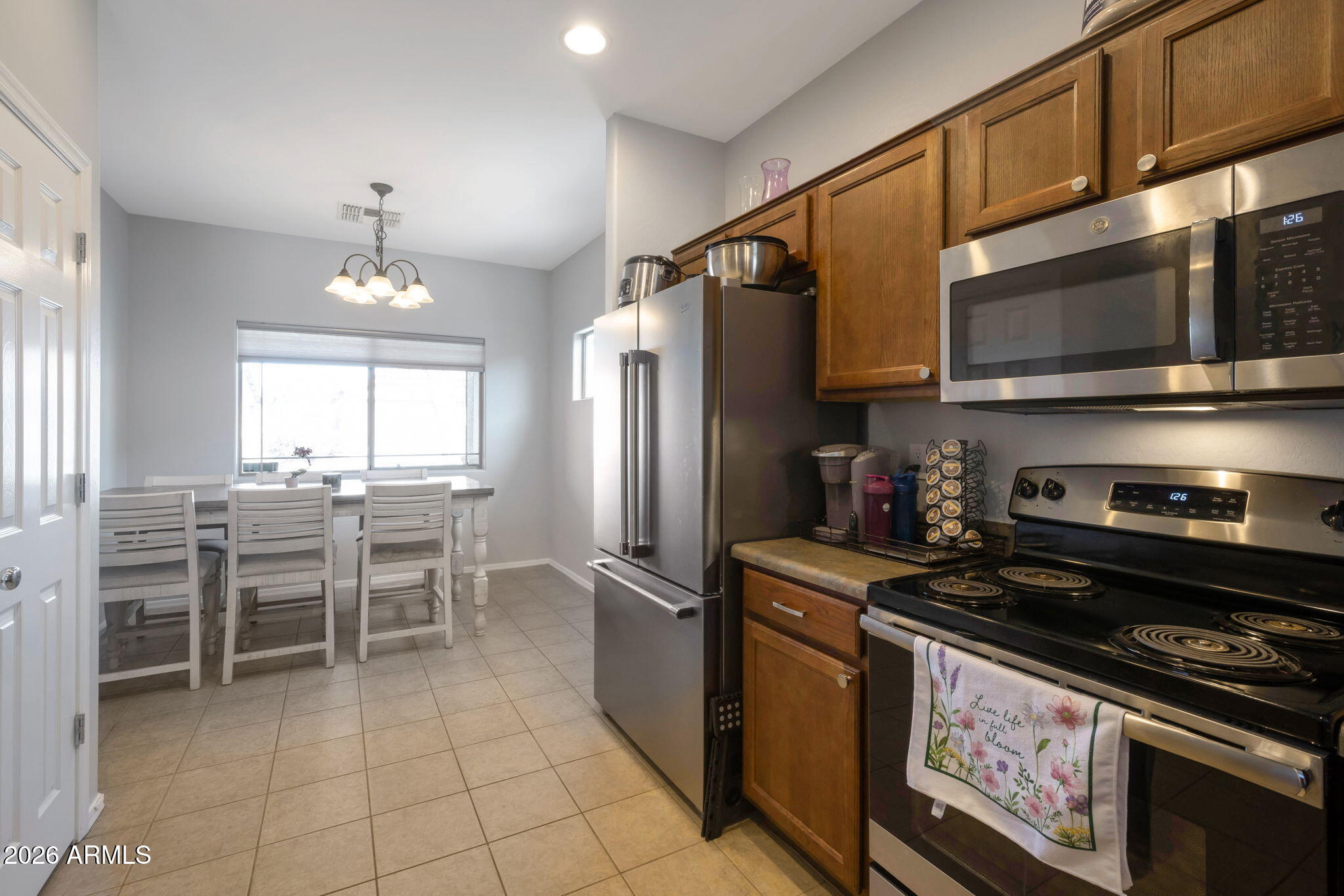 225 West Reeves Avenue Queen Creek, AZ 85140 - Photo 4 of 25 a kitchen with granite countertop a sink stainless steel appliances and cabinets