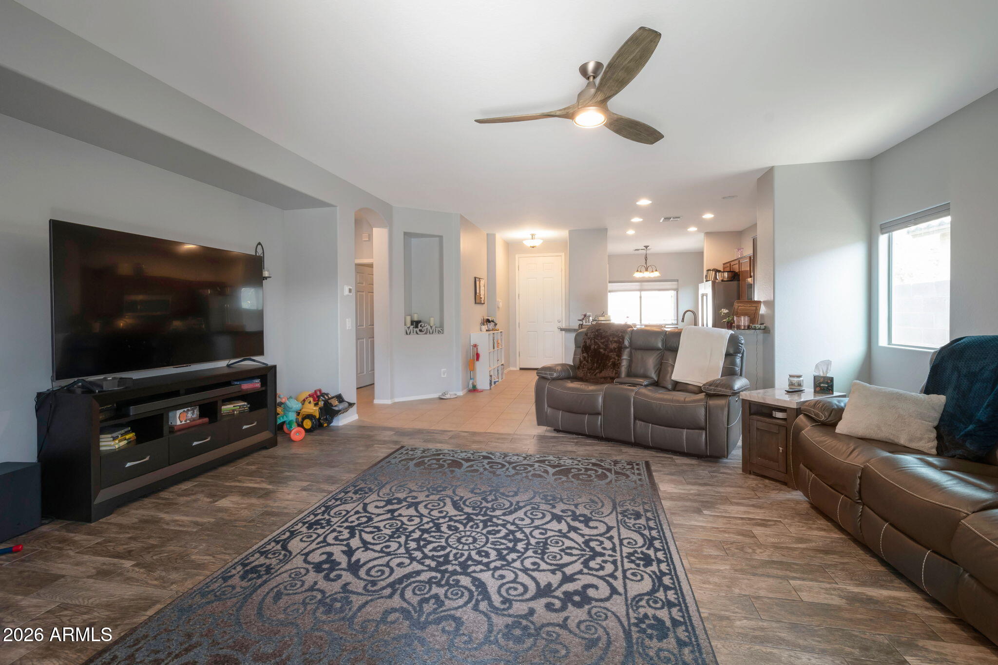 225 West Reeves Avenue Queen Creek, AZ 85140 - Photo 6 of 25 a living room with furniture and a flat screen tv
