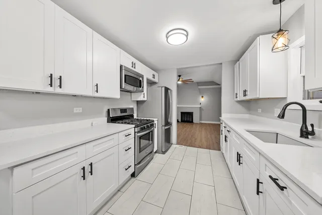 a kitchen with stainless steel appliances granite countertop a sink and cabinets