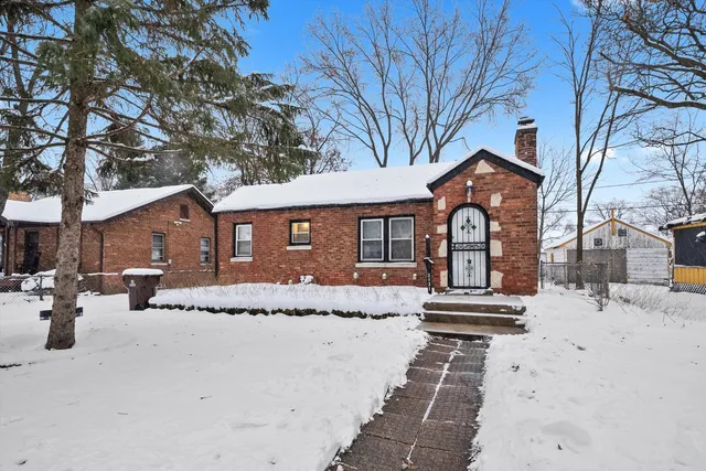 a front view of a house with yard covered in snow