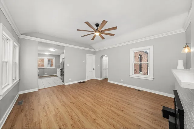 a view of a livingroom with a window and wooden floor