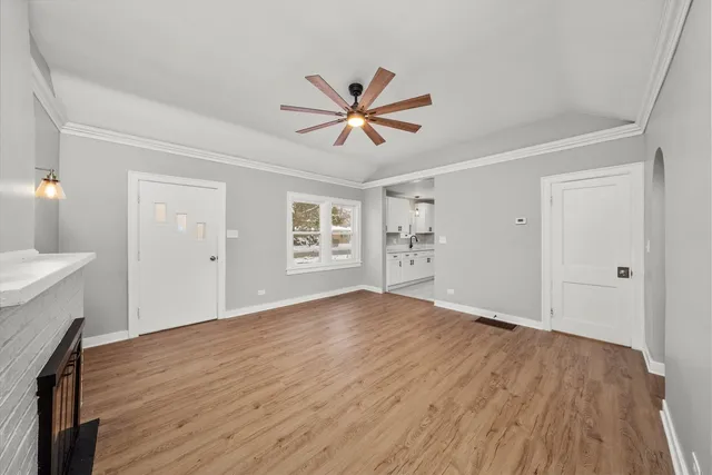 a view of a livingroom with a hardwood floor and a ceiling fan