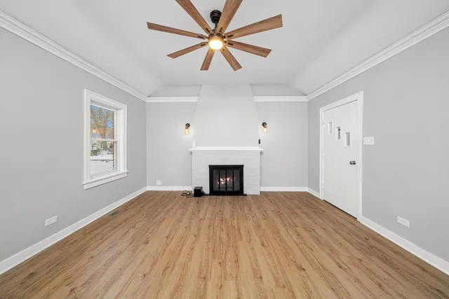 an empty room with windows and a fireplace