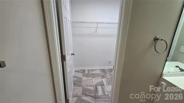 an empty room with wooden floor and entryway