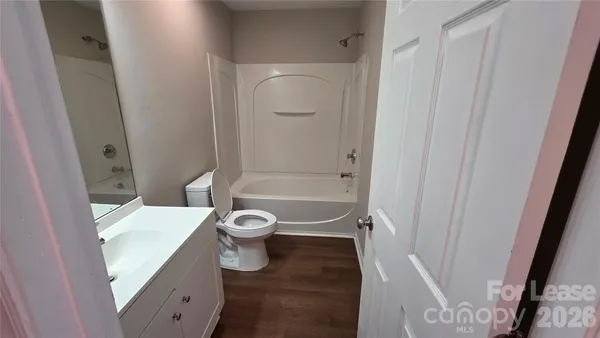 a view of hallway with wooden floor