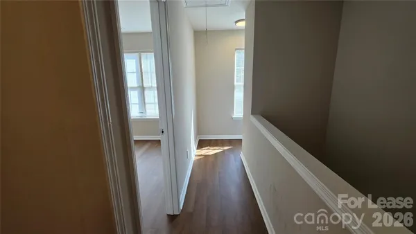 a view of an empty room and wooden floor