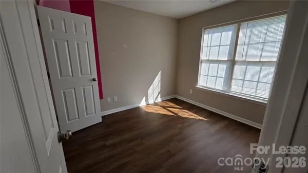 an empty room with wooden floor