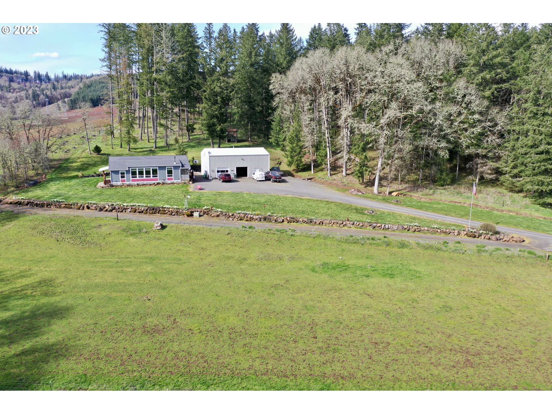 39489 Kingston Jordan Road Scio, OR 97374 - Photo 2 of 47 a white house with a big yard with large trees