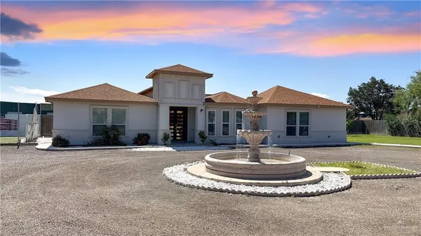 a front view of a house with a yard fire pit and outdoor seating