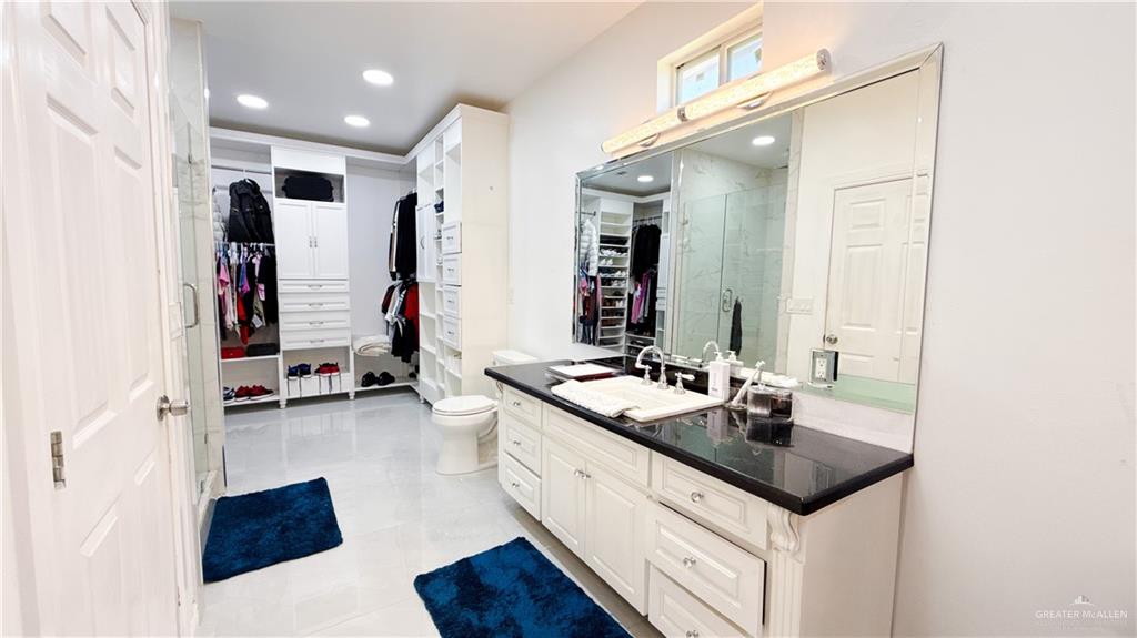 1301 Minnesota Road Pharr, TX 78577 - Photo 11 of 28 a en suite bathroom with double vanity and a mirror