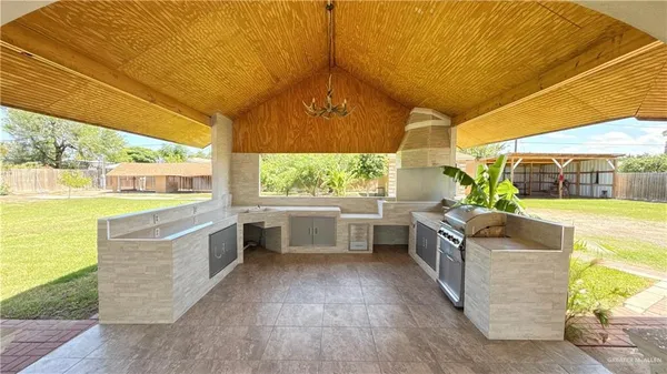 a view of a house with a yard and sitting area