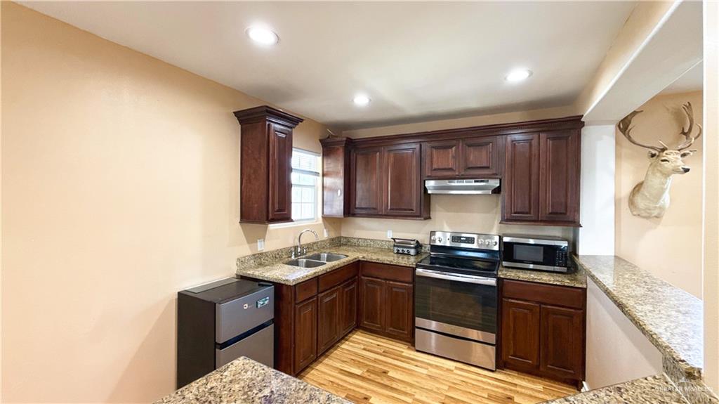 1301 Minnesota Road Pharr, TX 78577 - Photo 21 of 28 a kitchen with a sink stove top oven and refrigerator