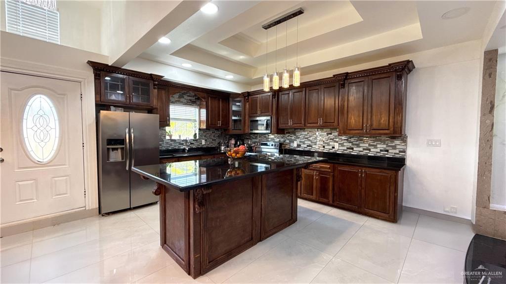 1301 Minnesota Road Pharr, TX 78577 - Photo 4 of 28 a kitchen with granite countertop stainless steel appliances a stove refrigerator and cabinets