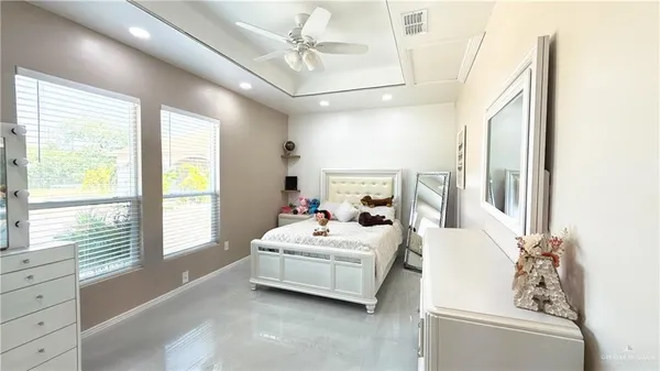 a bedroom with furniture and large window