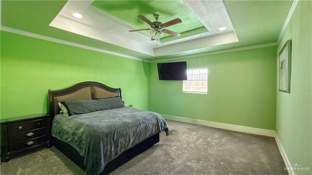 1301 Minnesota Road Pharr, TX 78577 - Photo 8 of 28 a bedroom with a bed and a ceiling fan