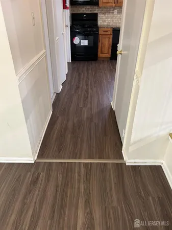 a view of a kitchen from a hallway