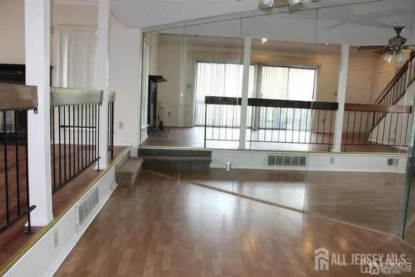 a view of entryway and hall with wooden floor