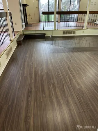 a view of balcony with wooden floor