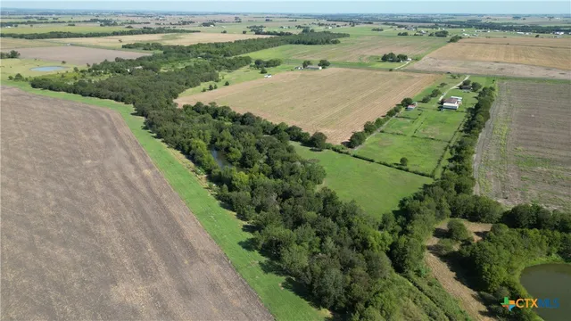 an aerial view of residential houses with outdoor space and street view