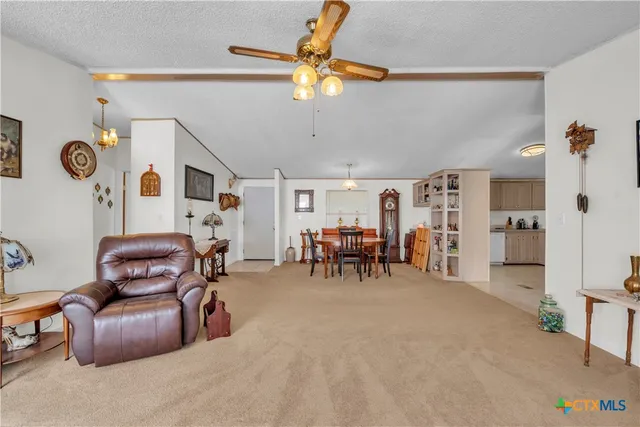 a view of a livingroom with furniture and windows