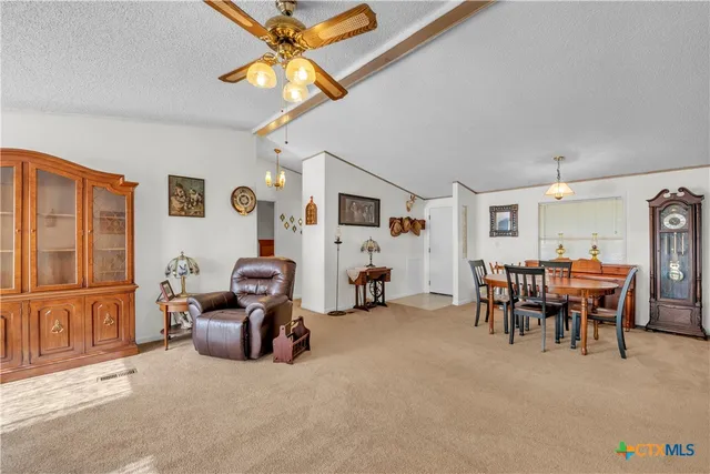 a kitchen with granite countertop a sink and white cabinets