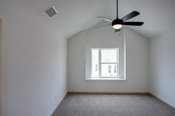 a view of room with a window and a ceiling fan