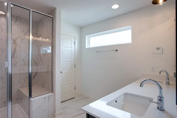 a bathroom with a double vanity sink and mirror